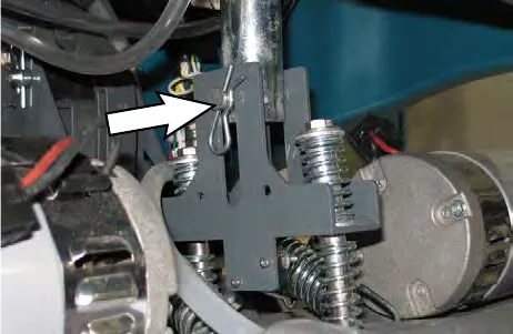 Arrow pointing to the clevis pin securing the actuator to the head suspension spring bracket