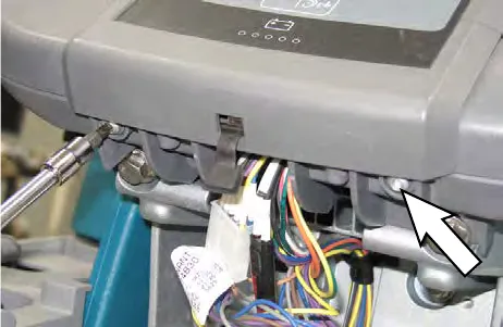 Arrow pointing to the pan screws holding the instrument panel