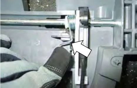 Arrow pointing to the bail return spring and bail handle shaft