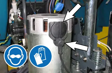 Arrow pointing to the access plug on the disk brush motor; safety glasses and gloves symbols shown