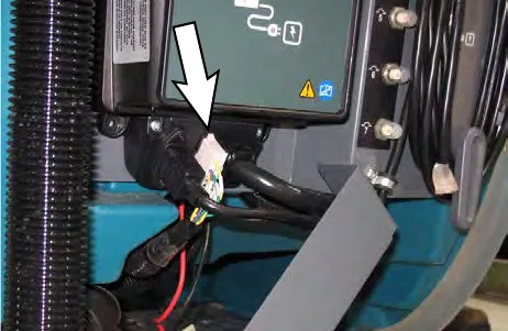 Arrow pointing to the cable connector on the on-board battery charger
