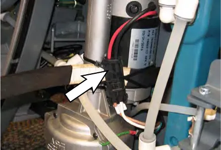 Arrow pointing to the main wire harness connection at the transaxle