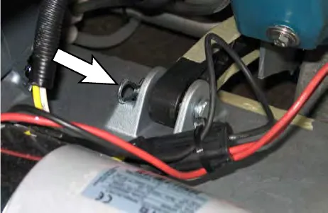 Arrow pointing to the head lift arm clevis pin