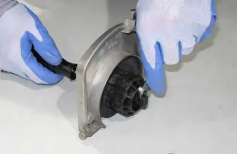 Hand turning the idler plug on the idler plate