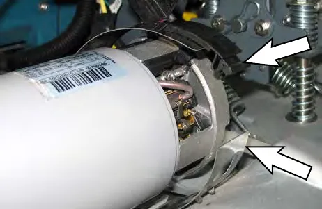 Arrows pointing to the retaining band latch on the brush motor