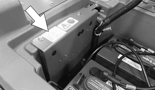 Serial number plate on the electrical mounting bracket inside the battery compartment, marked with an arrow