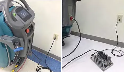 On-board charger cord plugged into a wall outlet and an off-board charger connected to the machine