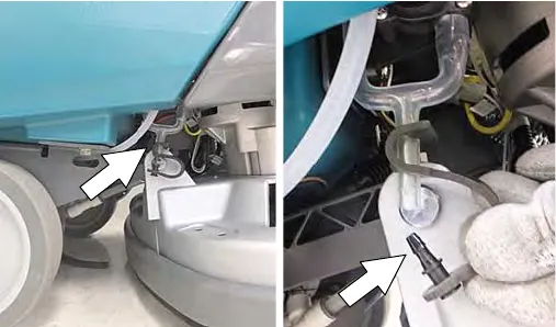 Arrow pointing to the battery watering drain hose below the tank, and the drain hose cap