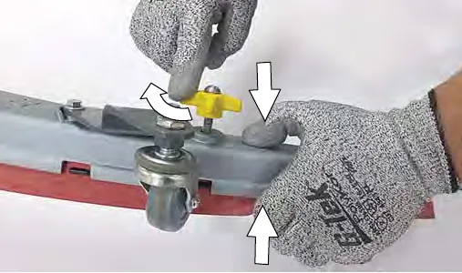 Squeezing the squeegee frame and blade retainer together while re-tightening a knob