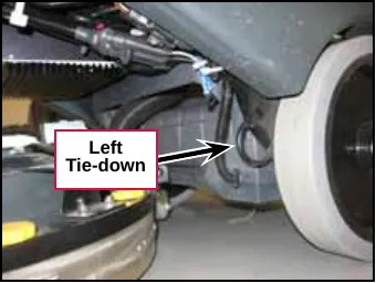 Photo of the left tie-down point beside the left rear wheel, labeled Left Tie-down