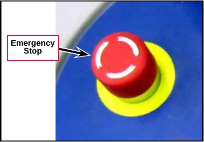 Photo of the red emergency stop knob on a yellow base, labeled Emergency Stop