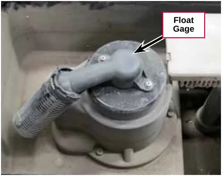 Photo of the float gage on top of the vacuum motor housing in the recovery tank