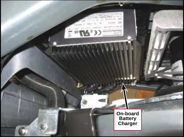 On-board battery charger, a finned black unit mounted under the machine above the scrub deck, with a callout reading On-board Battery Charger
