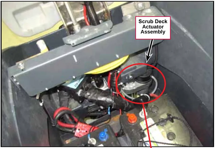 Photo of the machine frame with the Scrub Deck Actuator Assembly labeled and circled