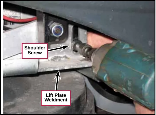 Impact driver removing the shoulder screw at the lift plate weldment. Labels: Shoulder Screw, Lift Plate Weldment.