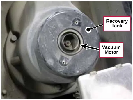 Photo of the top of the vacuum motor centered in the cutout in the recovery tank