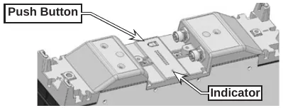 Photo of the top of a battery module showing the push button and the indicator