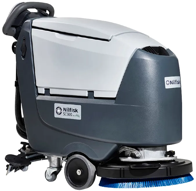 Nilfisk SC500 walk-behind floor scrubber seen from the front left: dark gray body, light gray recovery tank cover, handlebar with control panel at the rear and the round disc brush deck at the bottom