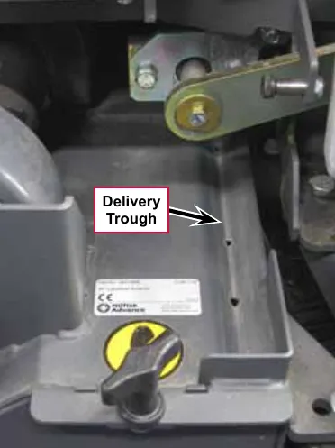 Photo of the solution delivery trough on a cylindrical deck with a callout and arrow labeled Delivery Trough, showing the small holes along the trough