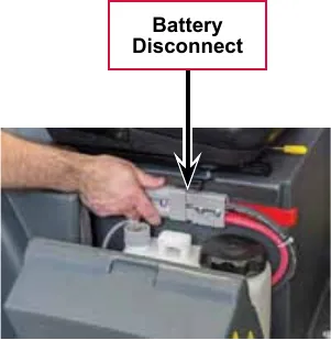 Photo of a hand pulling apart the grey battery disconnect connector