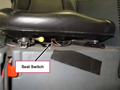 Photo of the underside of the seat with a callout for the Seat Switch