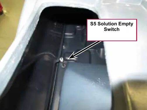 Photo looking down through the solution tank fill opening with a callout and arrow pointing to the S5 Solution Empty Switch