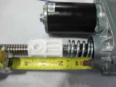 Photo of a tape measure along the lead screw from the drive nut to the motor housing, retracted position, 1 3/4 inches.