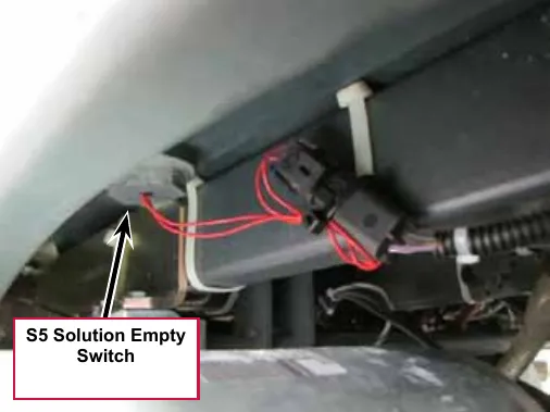 Photo from under the solution tank with a callout and arrow pointing to the S5 Solution Empty Switch and its wiring connector