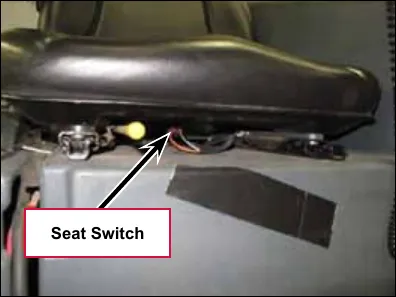Photo of the operator seat with the seat switch labeled below it