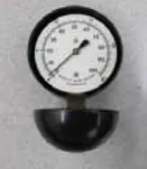 Photo of the vacuum water lift gauge, a round dial gauge on a black rubber cup