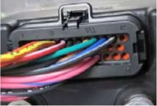 Photo of the 35-pin low current connector on the controller with colored wires in its pins