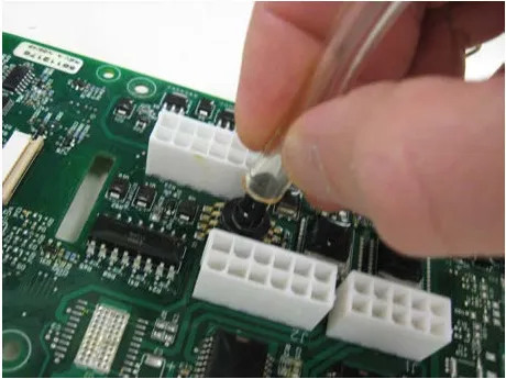 Fingers pushing the clear tube onto the sensor port of a new circuit board