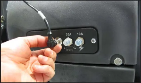 Hand unplugging the handle wiring lead next to the 30A and 10A circuit breakers