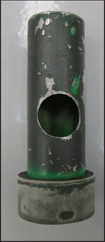 A short length of pipe with a round 1 inch hole cut in its side, set on a base