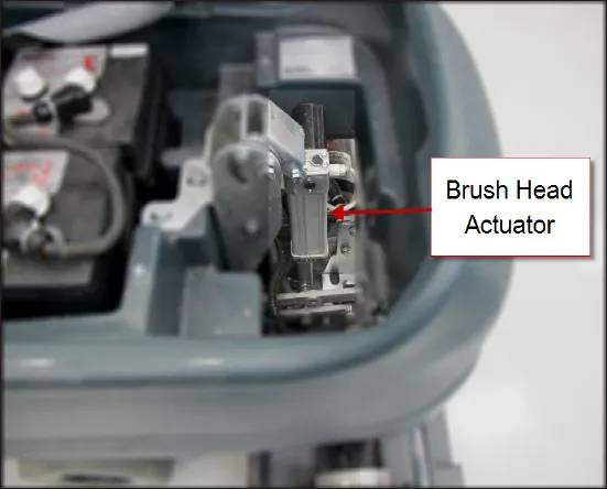View into the battery compartment area with the brush head actuator labeled