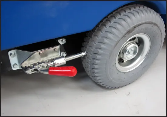 Optional parking brake kit: a manually operated lever with a red handle mounted beside a drive wheel, with its plunger pointing at the wheel