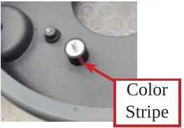Photo of an installed isolator with an arrow and the label Color Stripe.