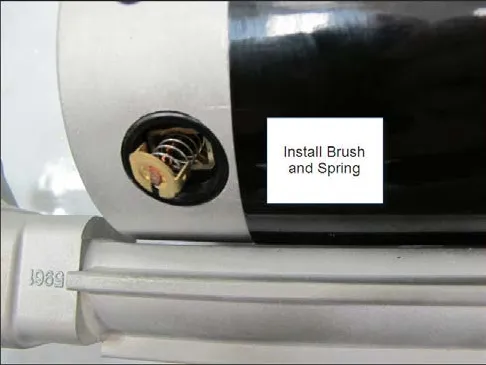 Photo of a carbon brush and spring being installed in the motor, labeled Install Brush and Spring