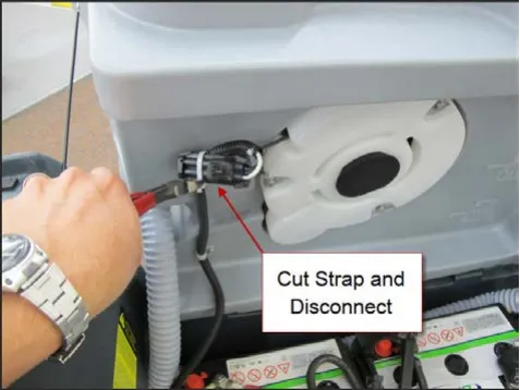 A hand cutting the tie strap on the vacuum motor electrical connector with side cutters, with an arrow from the label “Cut Strap and Disconnect”