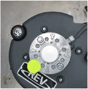 Photo of the top of the scrub head showing the isolator covers and the REV label.