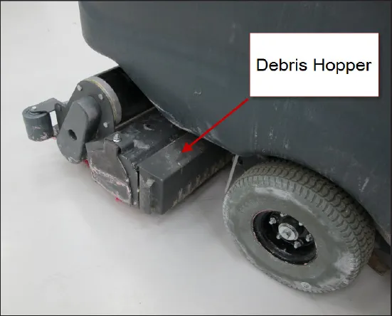 Side of the machine with the debris hopper labeled, beside the rear wheel