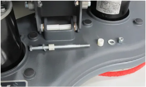 Photo of the brush head with the through bolt, washers and bushings removed and laid out beside it.