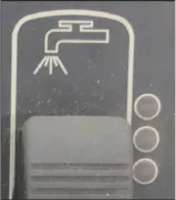 Solution toggle switch with a faucet icon above it and three indicator lights beside it