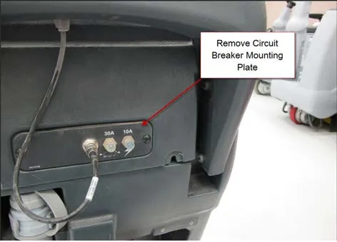 Back of the handle area with the circuit breaker mounting plate showing a 30A and a 10A breaker and a callout reading Remove Circuit Breaker Mounting Plate