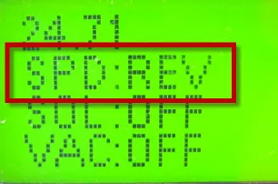 Service test mode LCD with the SPD:REV line outlined in red above SOL:OFF and VAC:OFF, battery voltage 24.71 on the top line