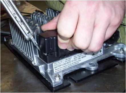 Hand lifting the black DC connector cover off the Delta-Q charger