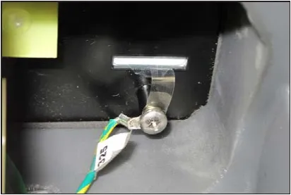 Ground wire ring terminal held by a screw behind the control switch interface panel