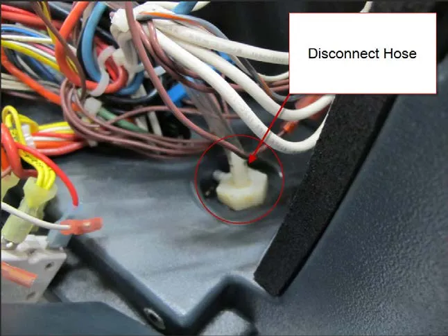 Wiring bundle with a callout reading Disconnect Hose, pointing to the white pressure sensor hose fitting at the solution tank circled in red