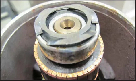 Wave washer seated on the armature shaft above the commutator