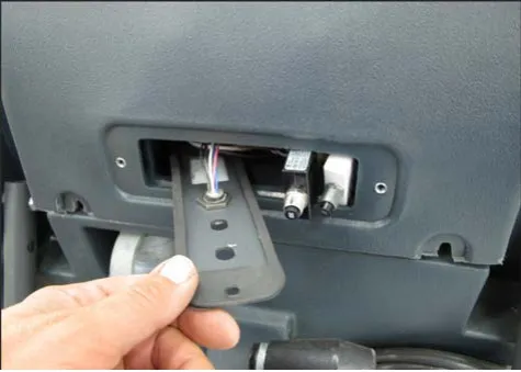 Hand pulling the circuit breaker mounting plate partway out of the cover opening